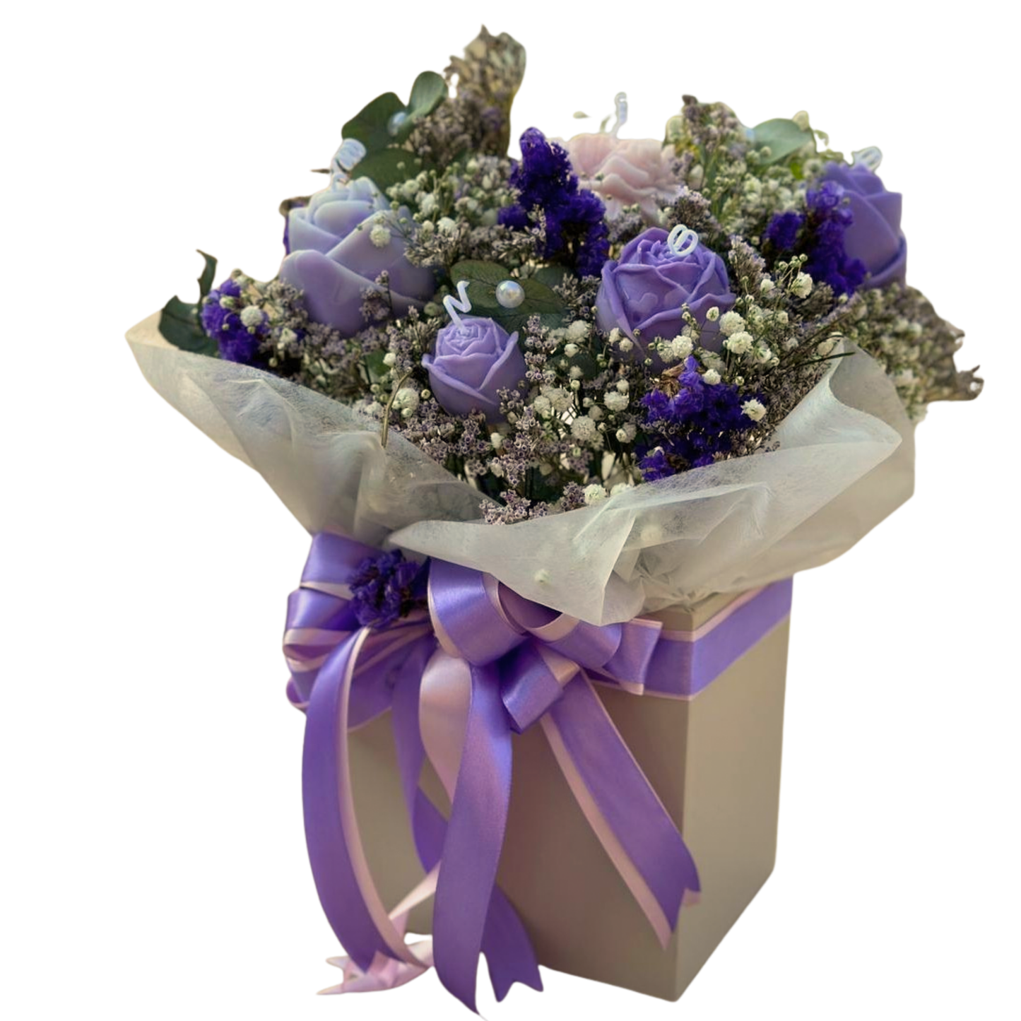 Purple Paradise is of purple and pink flower candles arrangement with fresh flower fillers and eucalyptus leaves, in a box with purple and pink satin ribbon.