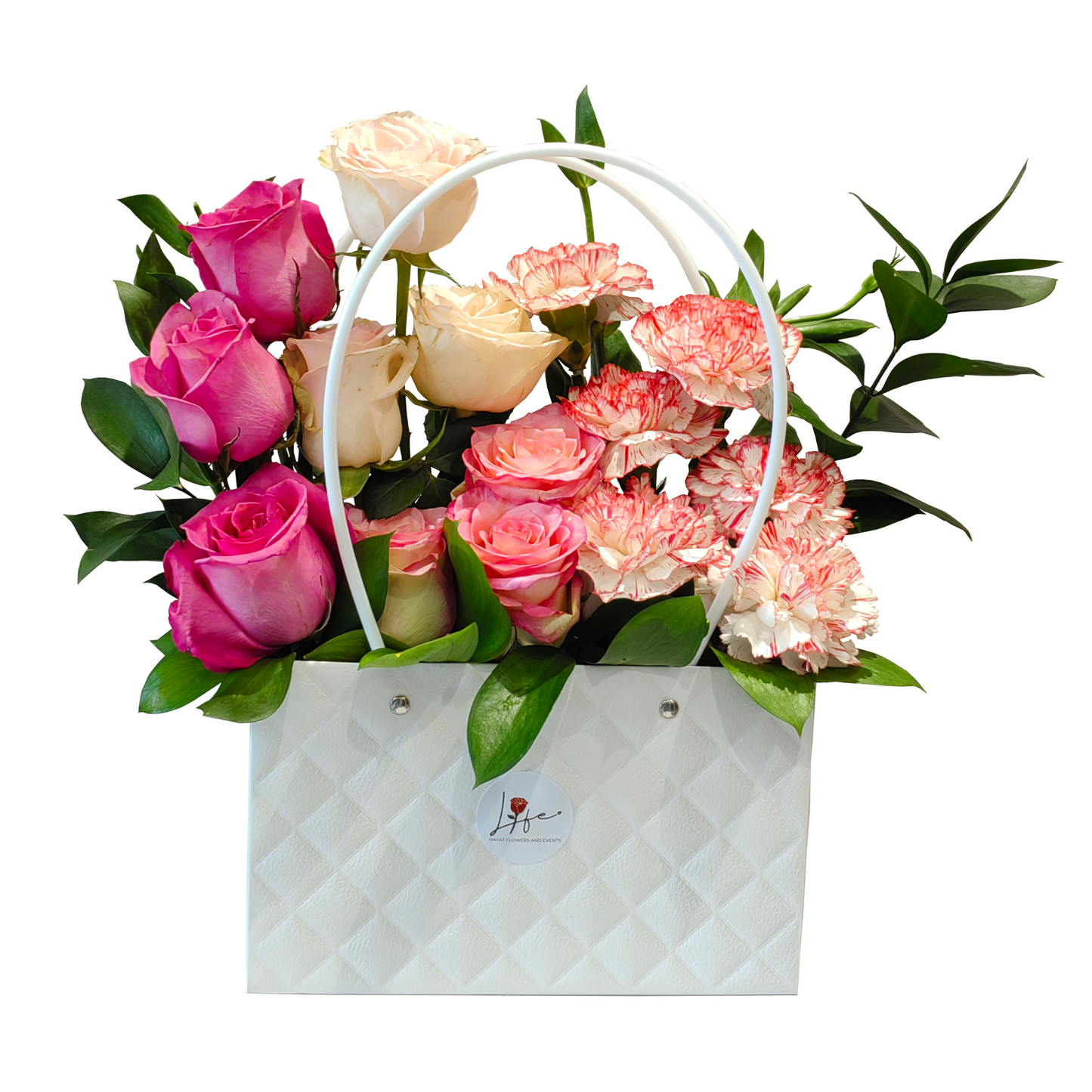 White quilted handbag floral arrangement with pink and cream roses, white-pink carnations, and green foliage –-Blush Bloom Bag by Hayat Flowers.