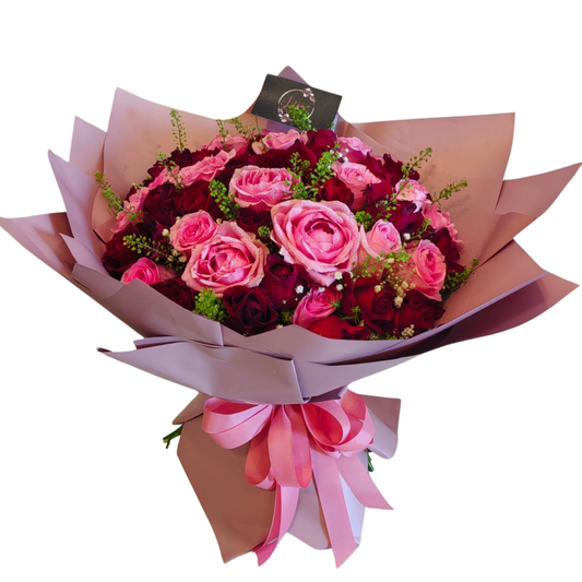 Bouquet of 20 pink and 30 red roses wrapped in elegant pink floral paper with pink ribbon –-romantic 50-stem flower arrangement for gifting.