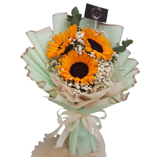 Hand-tied bouquet of sunflowers with white gypsophila and eucalyptus, wrapped in mint green floral paper with rose gold trim.