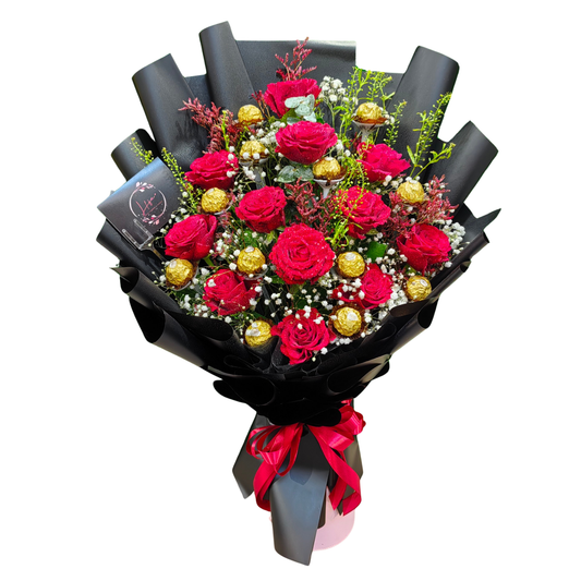 Luxurious red rose bouquet with Ferrero Rocher chocolates, eucalyptus, gypsophila, and red limoniums, elegantly wrapped for romantic gifting in Dubai.