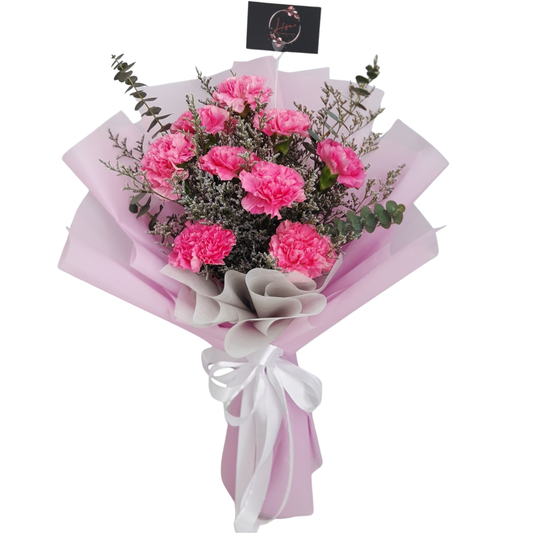 Blush pink flower bouquet featuring soft pink carnations, purple limonium, and eucalyptus leaves, wrapped in premium pink paper.