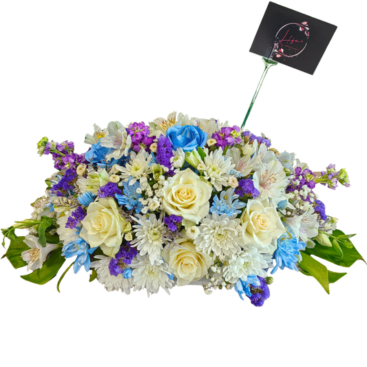 Divine Blooms centerpiece is an artistic harmony of fresh florals and foliage.