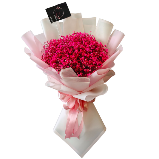 Fuschia Fantasy Bouquet with dark pink painted gypsophila wrapped in soft floral paper and finished with a pink satin ribbon by Hayat Flowers and Events