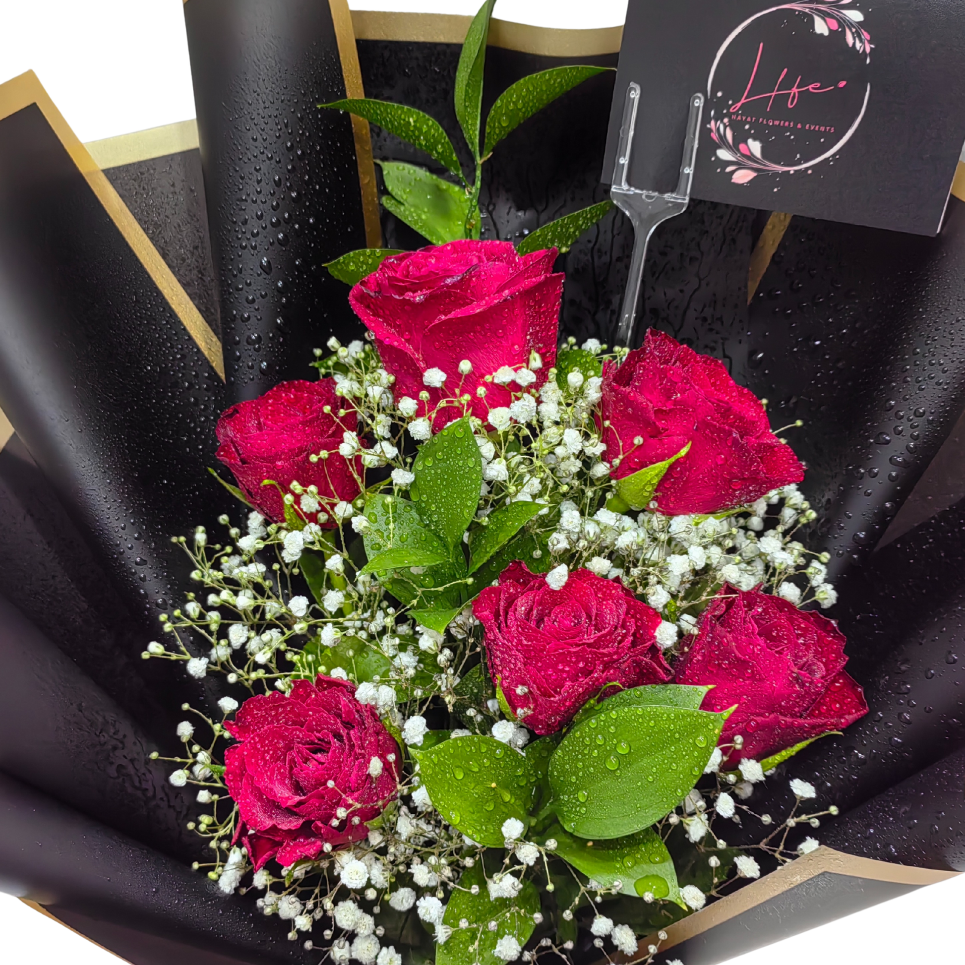 Hayat Flowers' Midnight Crimson-- a bouquet of  6 red roses, white gypsophila and single ruscus --luxuriously wrapped in black glossy paper with satin red ribbon finish.