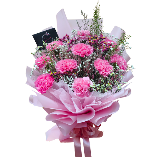 PINK JULIET Bouquet made of pink carnations with white gypsophila and limoniums elegantly wrapped with pink floral paper and fuchsia satin ribbon.