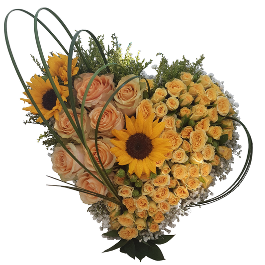 Heart-shaped floral arrangement of yellow and peach roses with sunflowers, white gypsophila, finished with ruscus and grass accents.