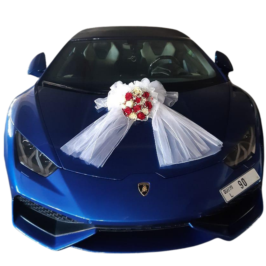LOVE ABLAZE wedding car bouquet wrapped with white chiffon fabric placed on the center of a blue Lamborghini sports car hood.